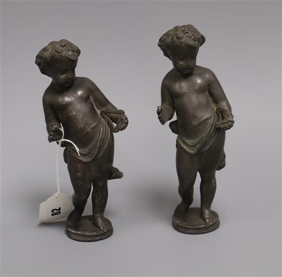 A pair of lead figures of cherubs Height 21cm